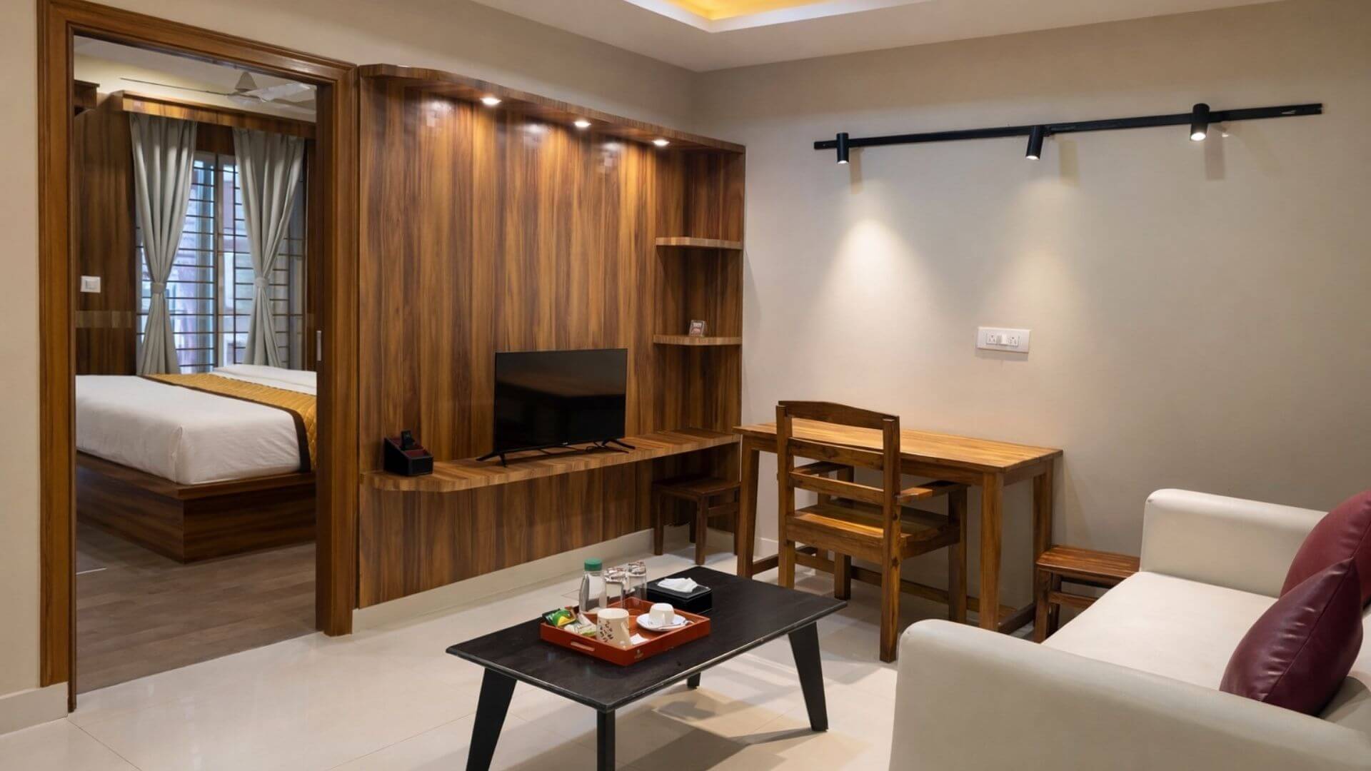 A Super Deluxe suite — the living area, dining table and the bedroom beyond