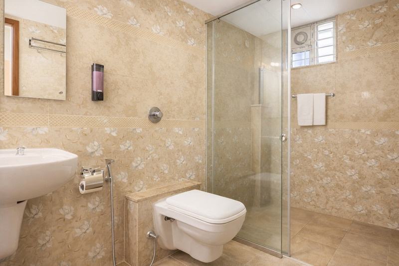 A finished bathroom with glass shower partition, softened hot water running year round