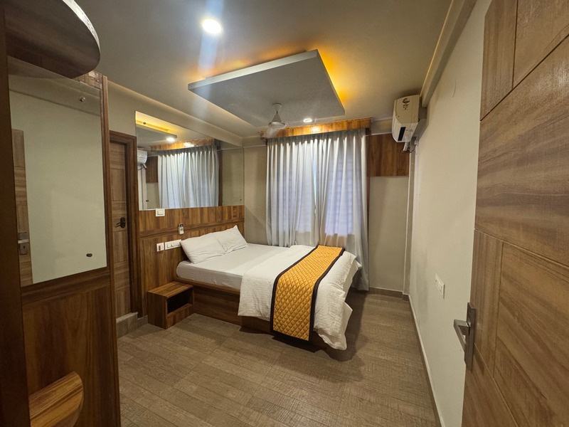 A furnished bedroom with king bed and headboard