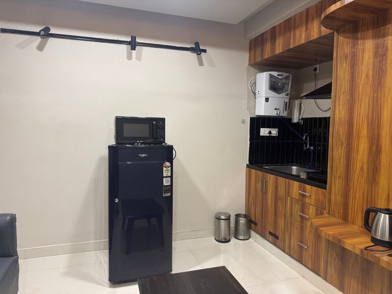The kitchenette with counter, sink and overhead storage