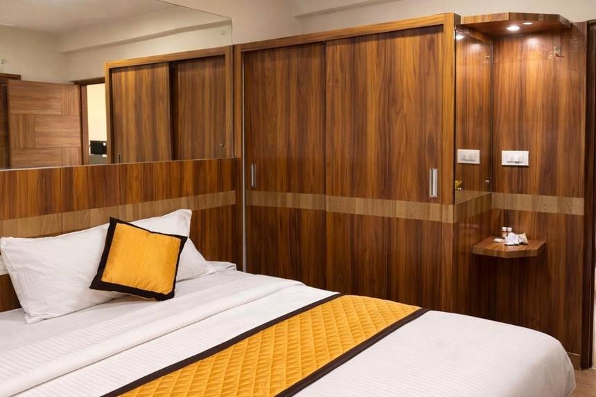 The bed against its panelled headboard wall