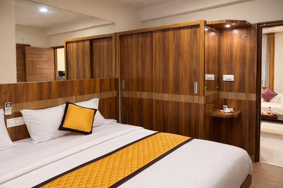 The bedroom, panelled wall to wall, bed made
