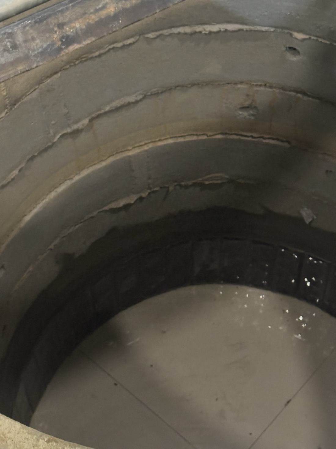 Looking down the finished shaft, concrete rings descending