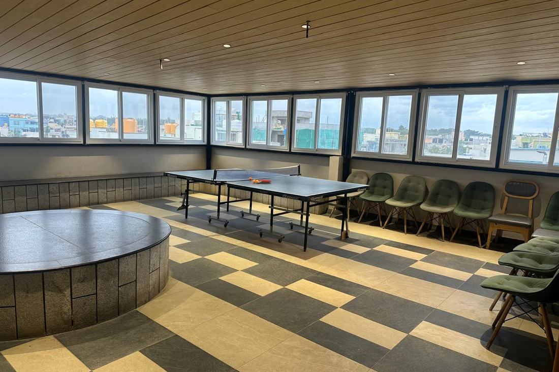 The indoor games room with a full-size table tennis table and city view